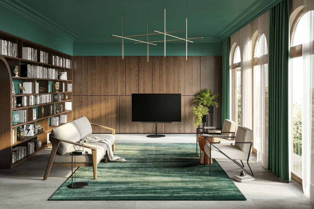 Phong khách phong thủy có concept màu xanh là và kệ sách âm tường