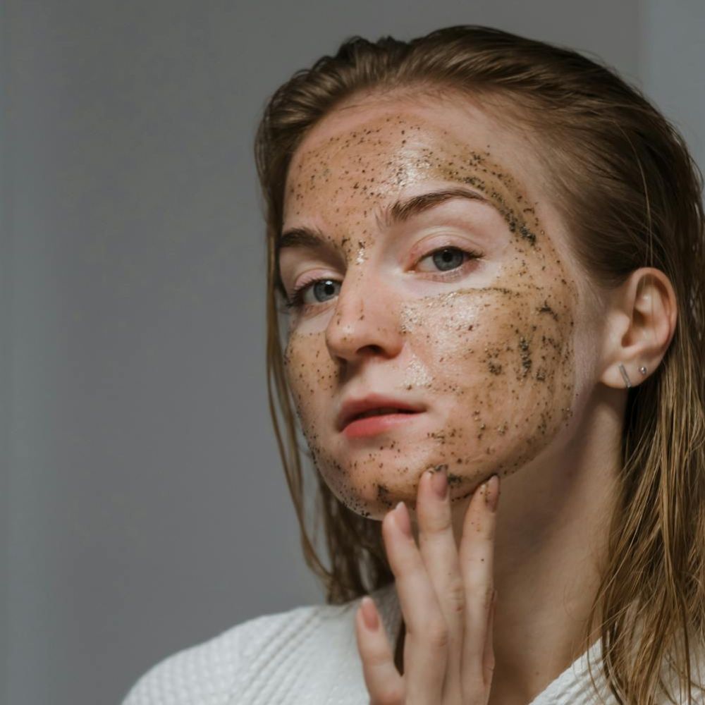 Hình ảnh cô gái với sản phẩm tẩy da chết vật lý dạng scrub.