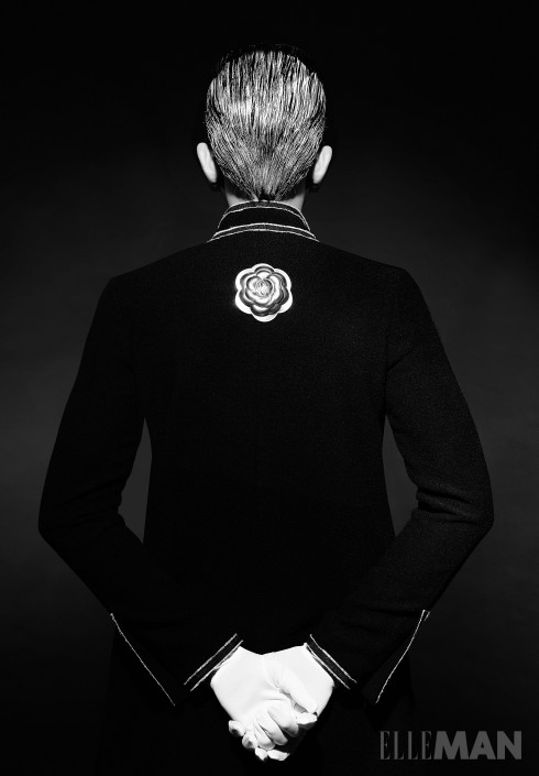 Little Black Jacket<br/>Áo khoác đen vải tweed kinh điển của Chanel, Cài áo hoa trà bằng kim loại Chanel, Găng tay của Stylist.