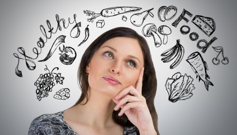 Young pretty woman thinking of healthy food closeup face portrai