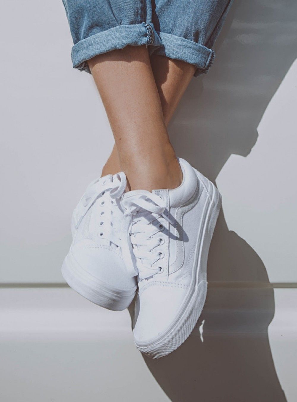 Dressed with white Vans tennis shoes