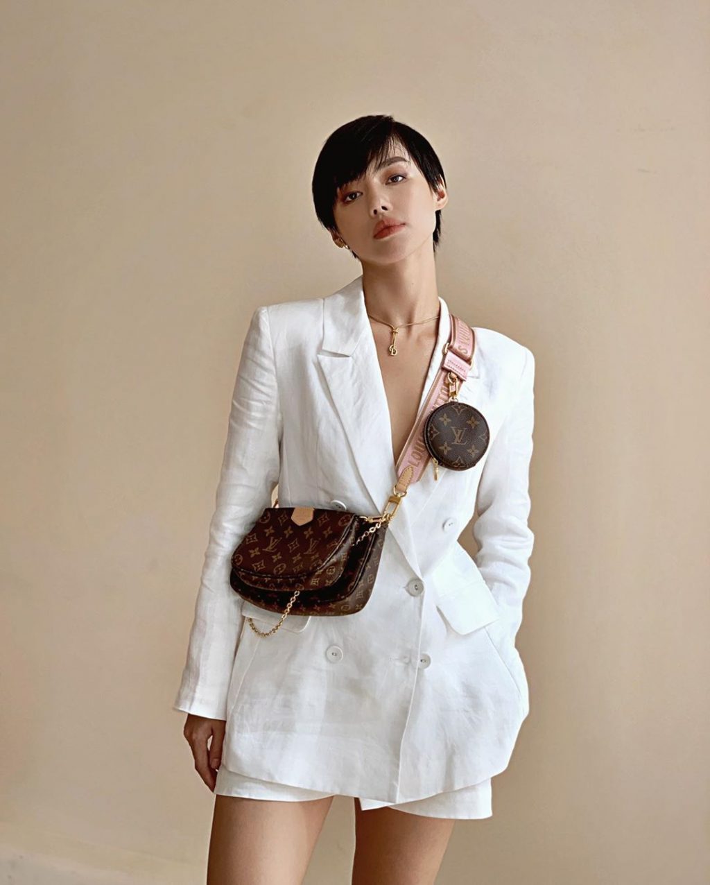 Khánh Linh diện Louis Vuitton Multi Pochette cùng suit trắng.