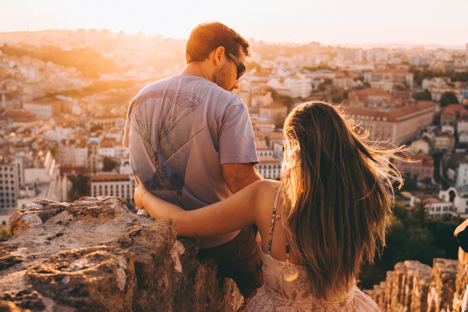 hai người yêu nhau đứng trên mỏm đá