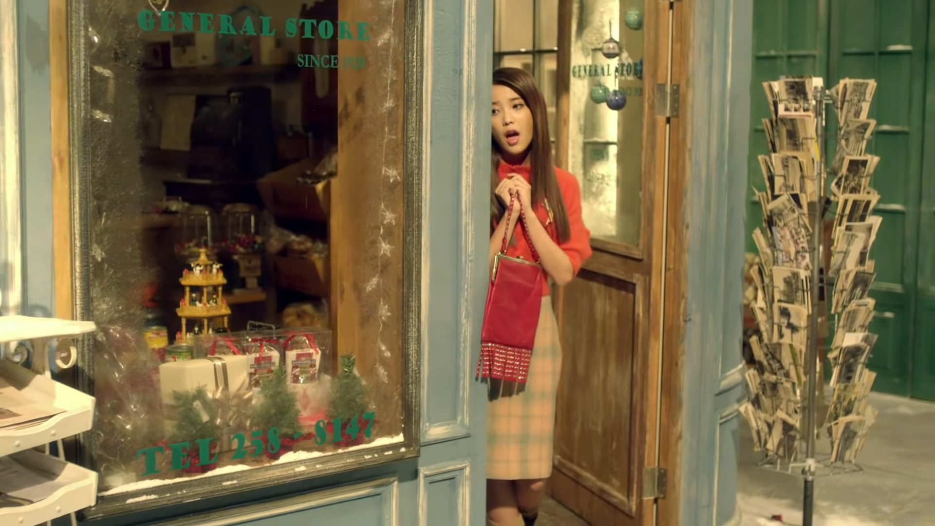 IU mặc áo len đỏ, chân váy kẻ ô trong MV Good Day 