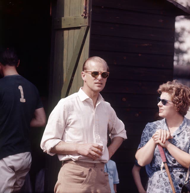 Prince Philip drinks a beer during Chukas as he prepares for a polo match at Ham Common, Richmond, 1961