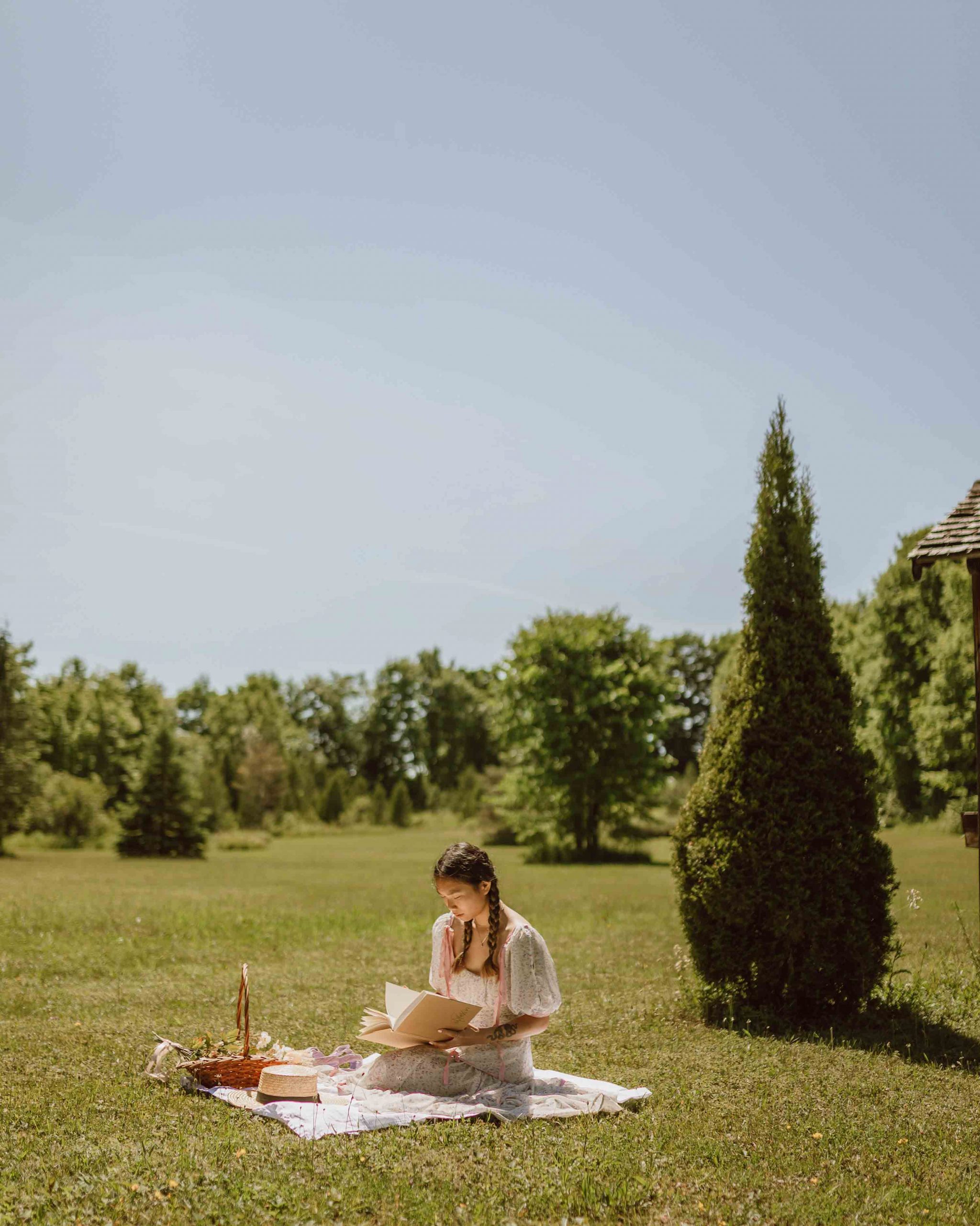 single girl picnic in the field jasmin chew unsplash