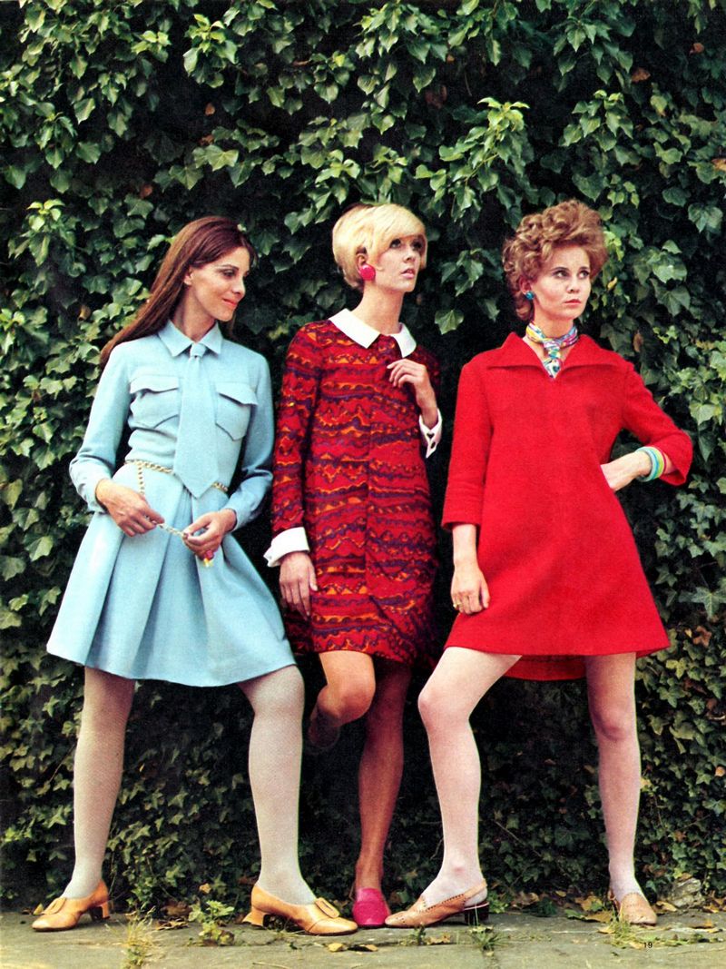 3 women standing in front of grass wall in 1960s style