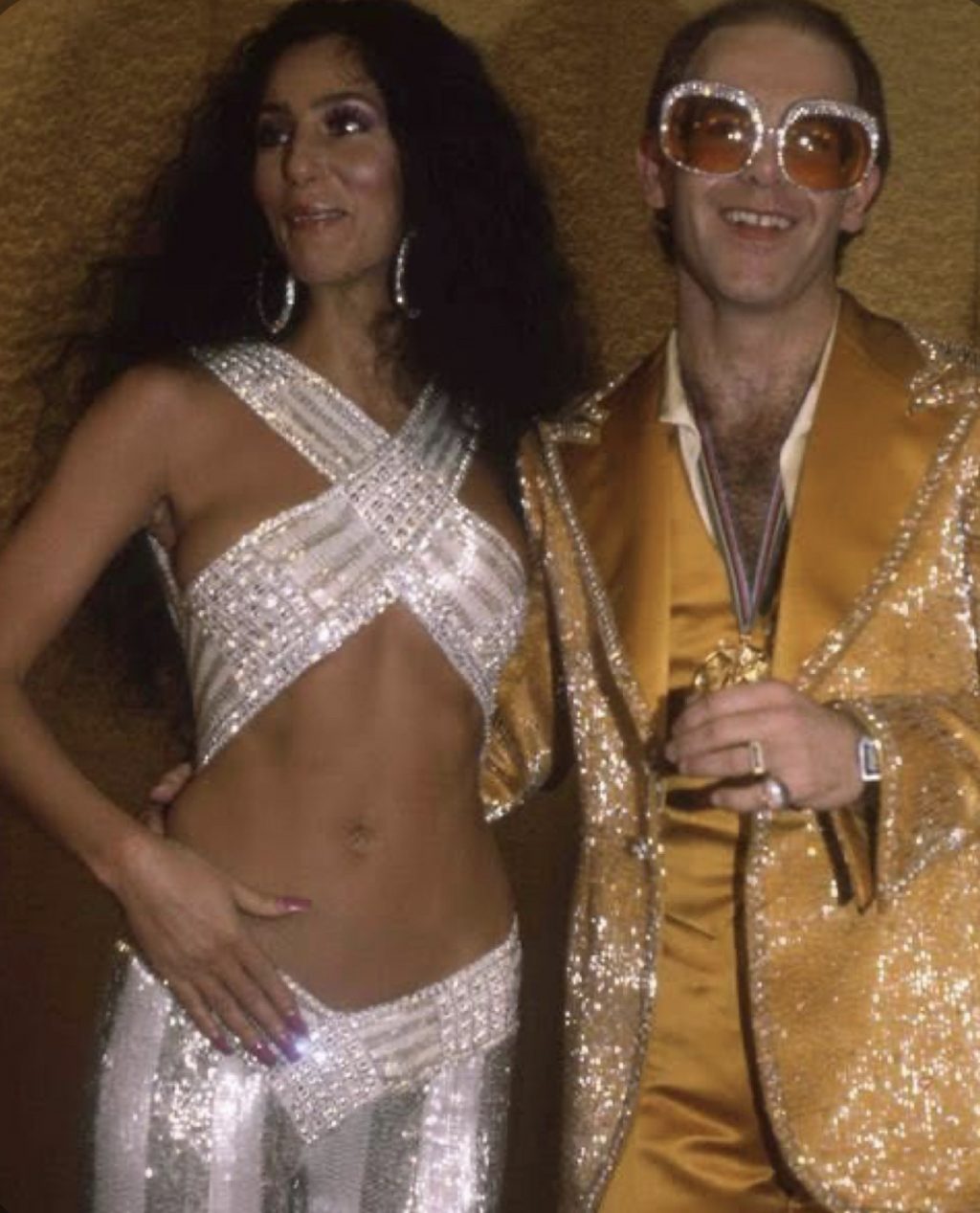 Elton John and Cher in glam rock style during 1980s