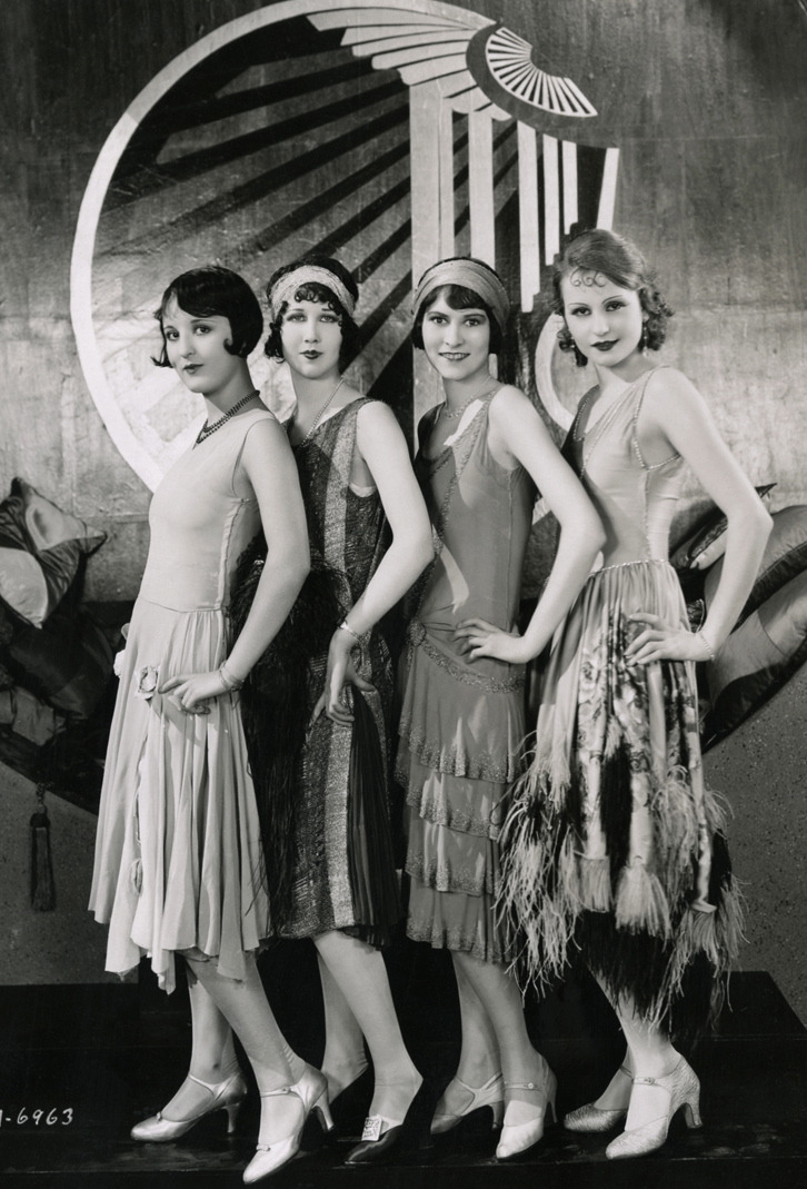 4 Flappers standing next to eachother in black and white